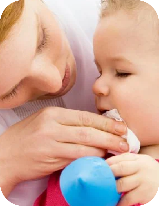 Mother cleaning her baby's mouth after vomiting