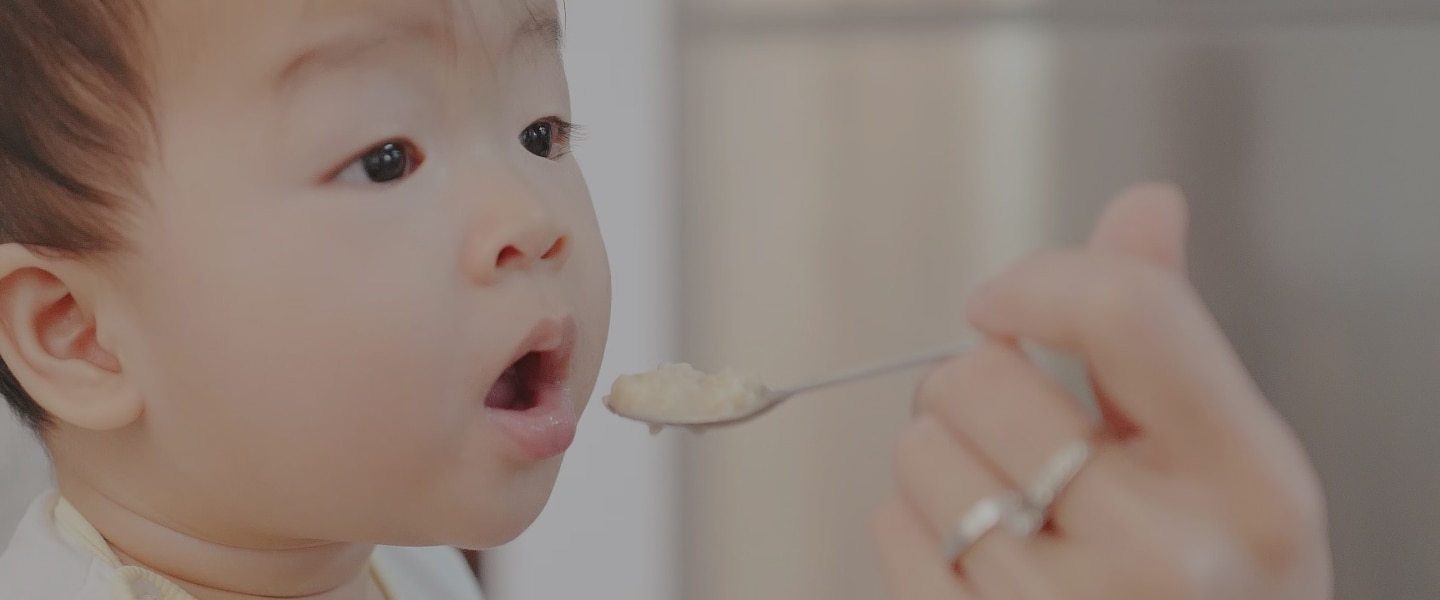 Baby eating friendly allergy food.